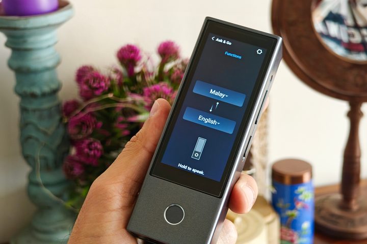 Timekettle AI interpreter hub with ask and go mode held in hand.