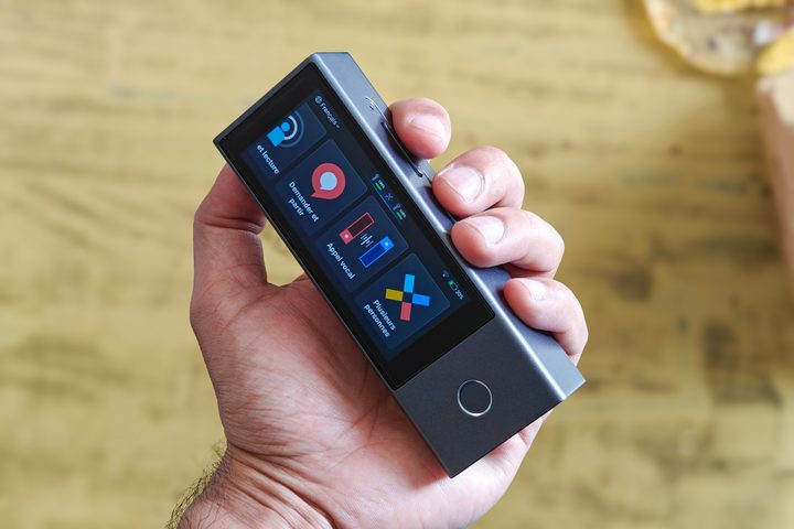 Timekettle AI interpreter hub held in hand.