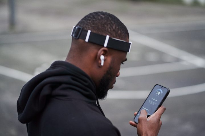 A person wearing the Alphabeats headband and using the app.