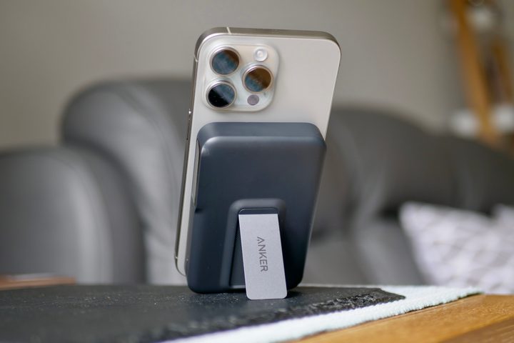 The iPhone 15 Pro Max being charged by the Anker MagGo Power Bank.