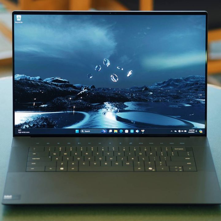 The open Dell XPS 16 on a table.