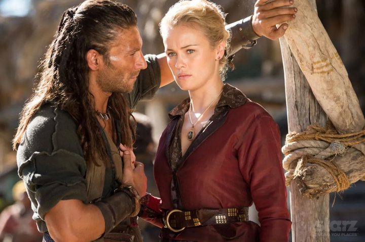 A man stands close to a woman in Black Sails.