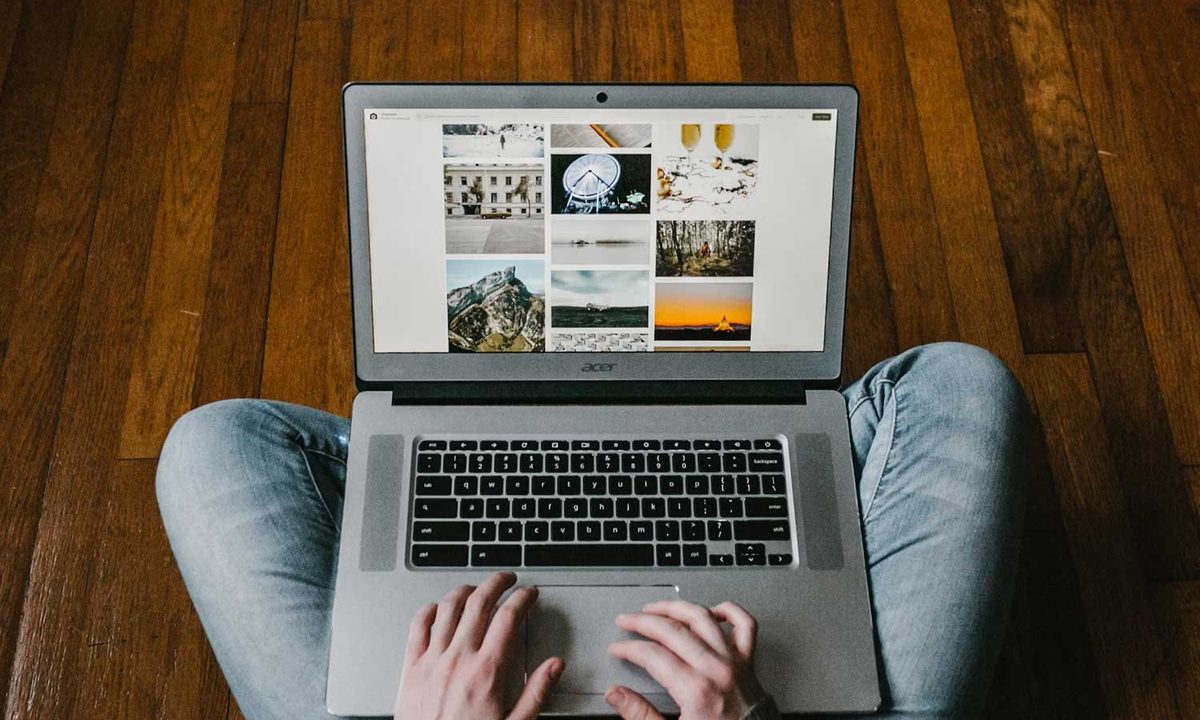 Person using their laptop on the floor.
