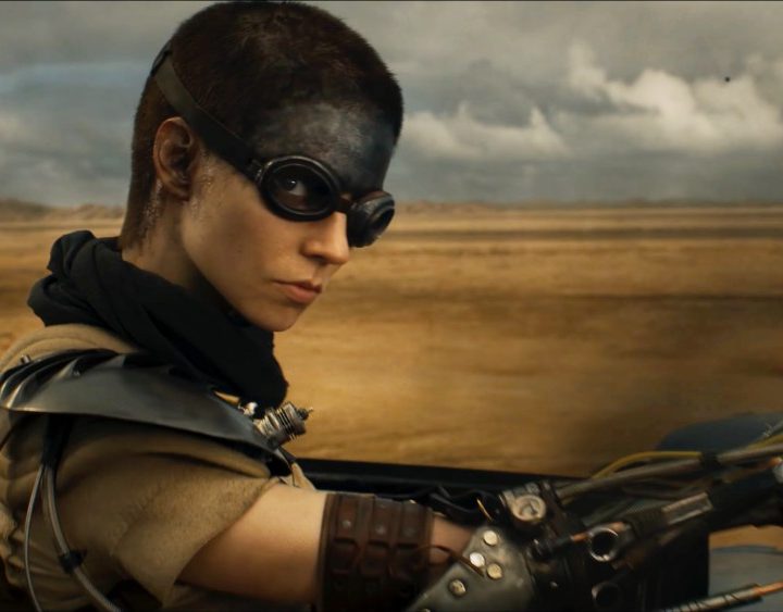 A woman rides her bike in Furiosa.