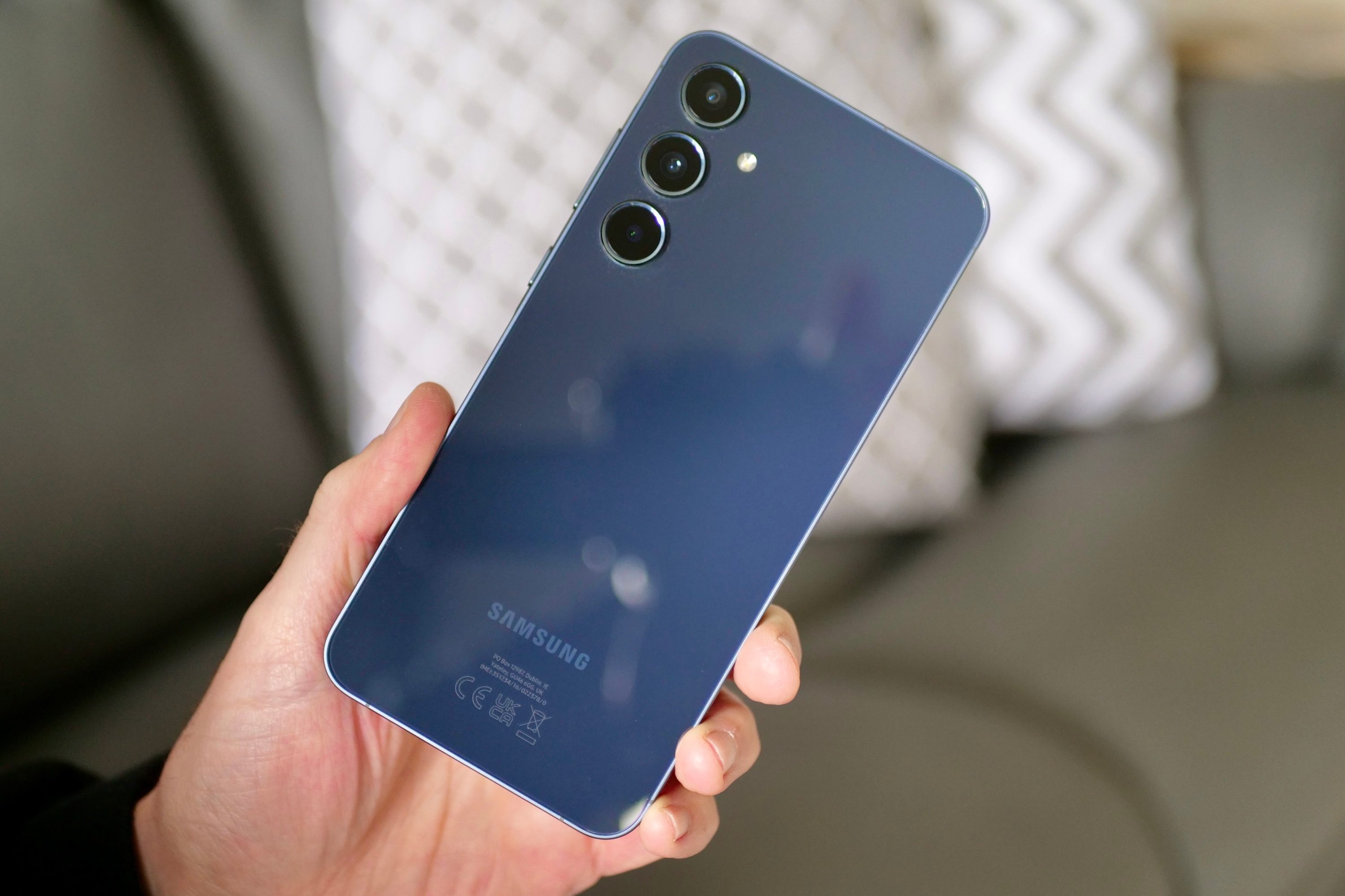 A person holding the Samsung Galaxy A55.