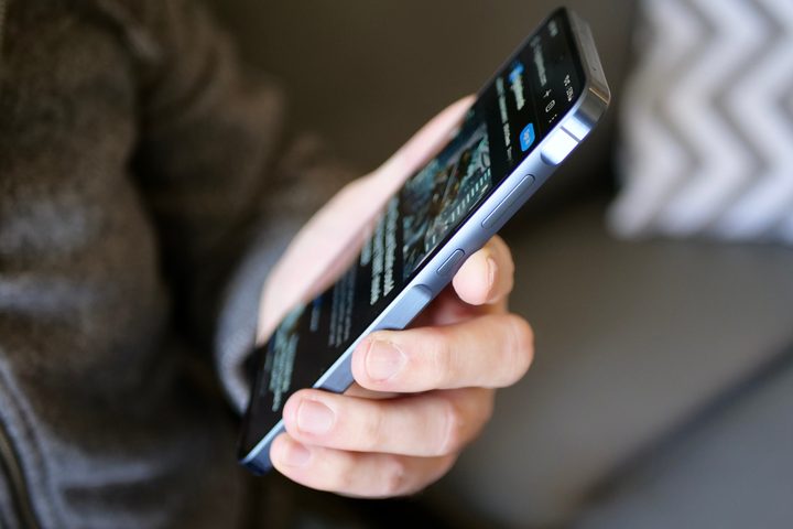 A person holding the Samsung Galaxy A55.