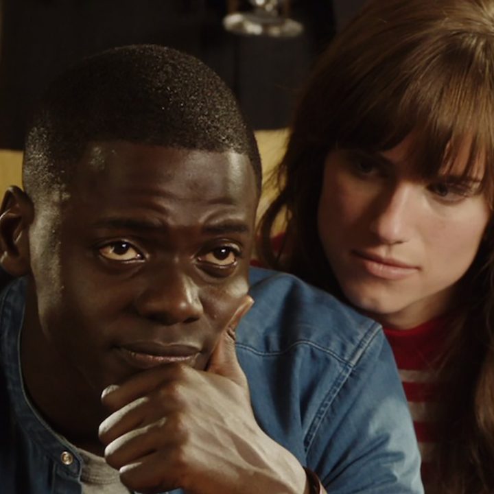 Chris looking worried, while Rose comforts him in a scene from Get Out.