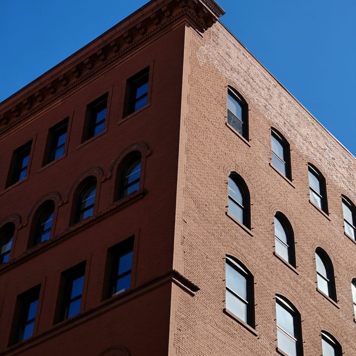 A photo of a brick building against a blue sky, taken with the Honor Magic 6 RSR.