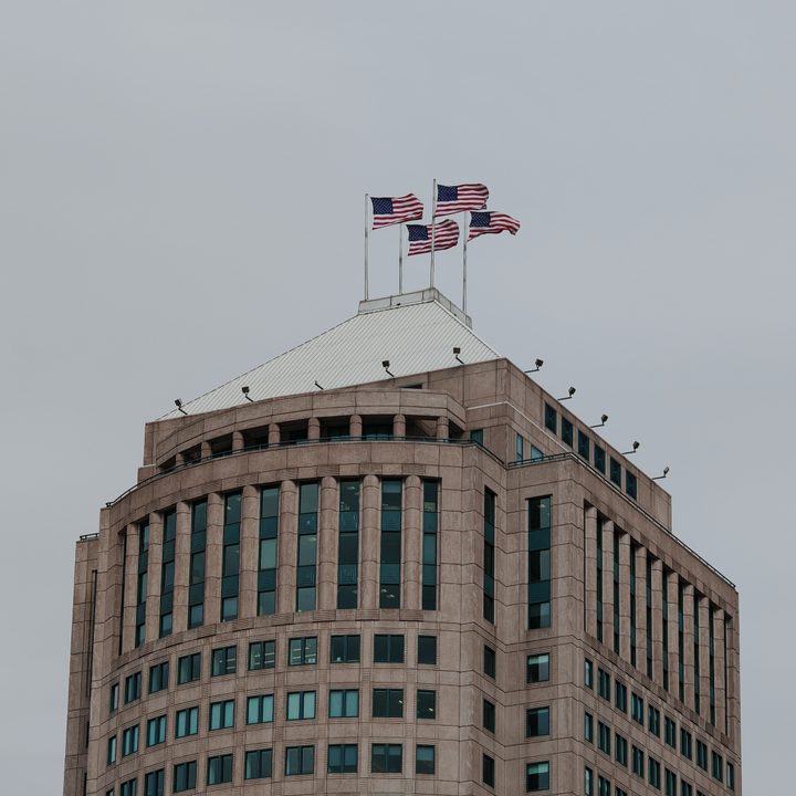 A photo of a building in Detroit with four American flags on top of it, taken with the Honor Magic 6 RSR.