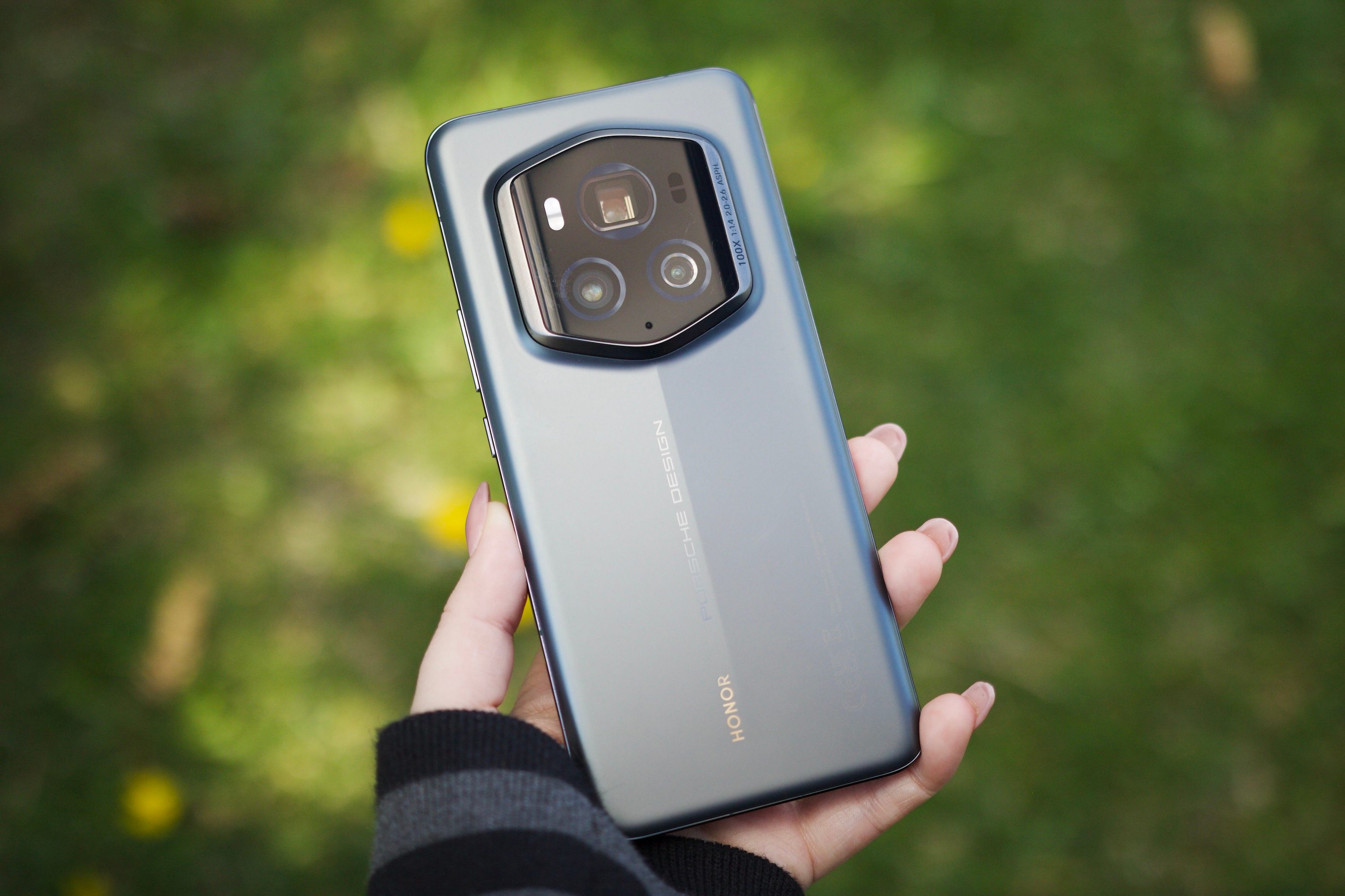 Someone holding the Honor Magic 6 RSR outside.