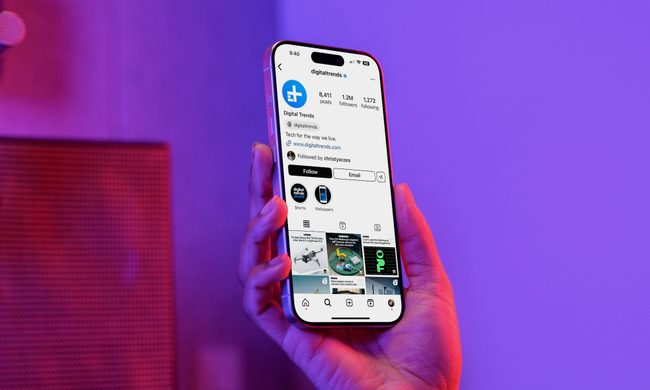A person holding a phone with the Instagram app open on it.