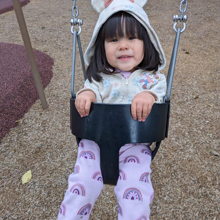 Toddler in swing taken with Google Pixel 7a.