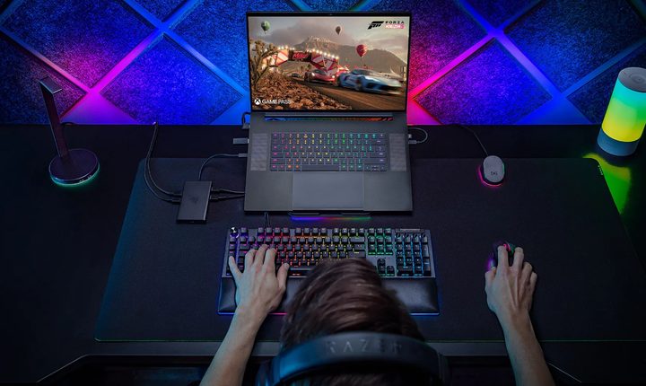 A person using the Razer Blade 18 2024 connected to various peripherals.