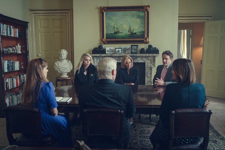People talk around a table in Scoop.