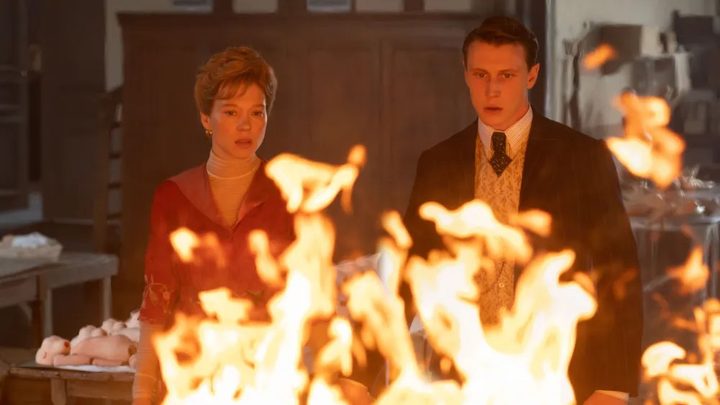 A woman and a man watch a fire in The Beast.