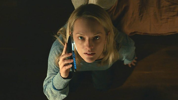 Elisabeth Moss looking up in an overhead view while on the phone in a scene from The Invisible Man.