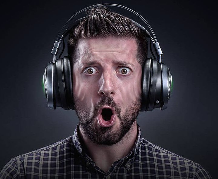 THX Spatial Audio image of a man looking surprised while wearing headphones.