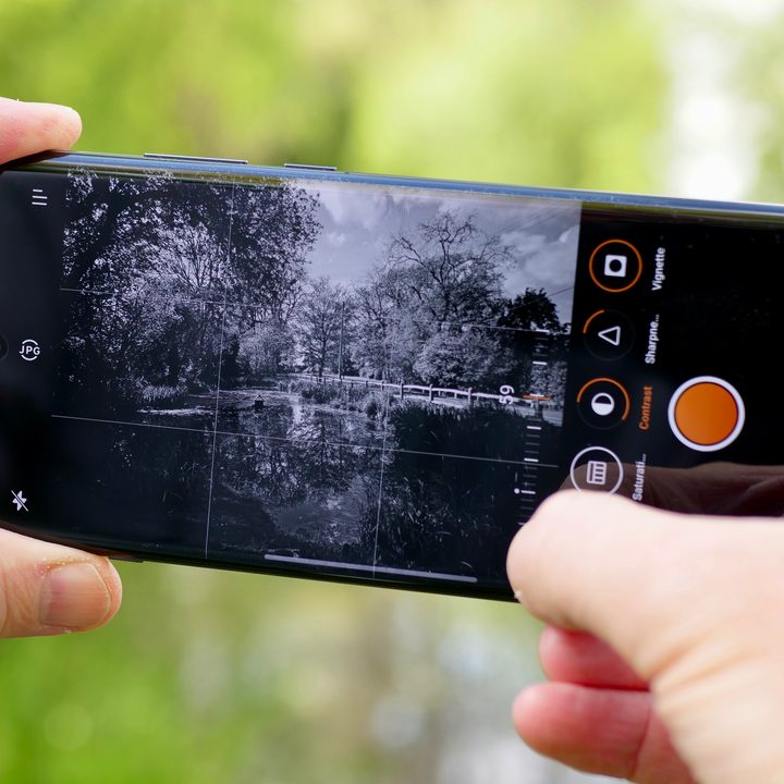 A person taking a photo with the OnePlus 12.