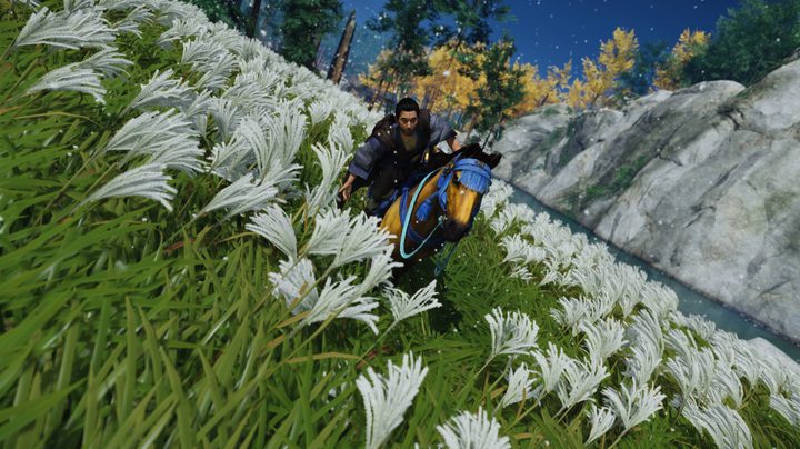 Jin riding through a field of flowers.
