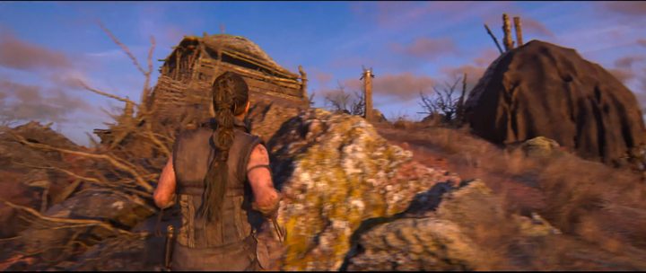 Senua approaching a lore totem in Hellblade 2.
