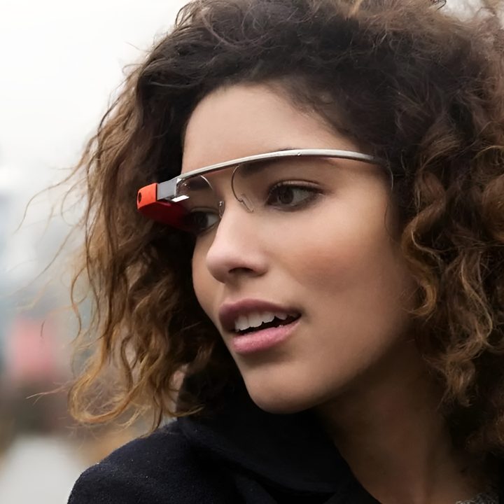 A closeup shot shows a person wearing Google Glass.