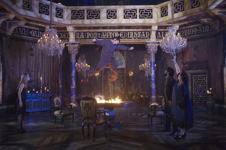 A possessed man floats above a burning table in Drag Me to Hell.