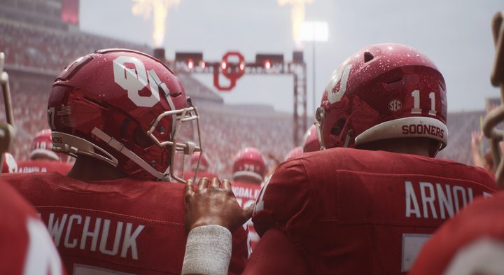 An Oklahoma football player with a hand on his fellow player's shoulder in College Football 25