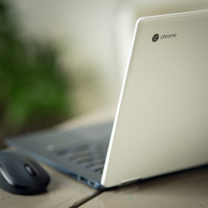 HP Chromebook with a mouse on a desk.