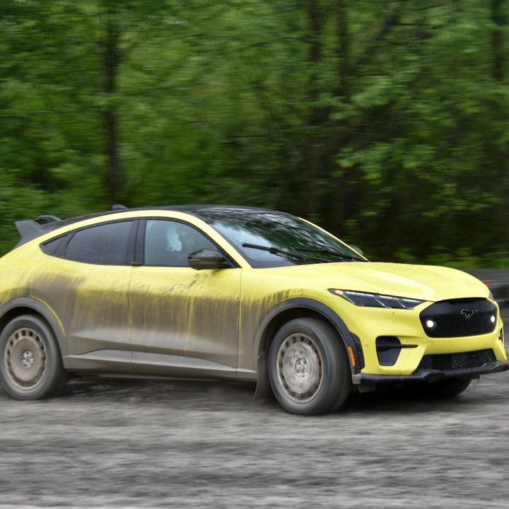 2024 Ford Mustang Mach-E Rally driving on dirt.