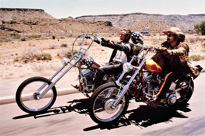 Two men ride bikes in Easy Rider.