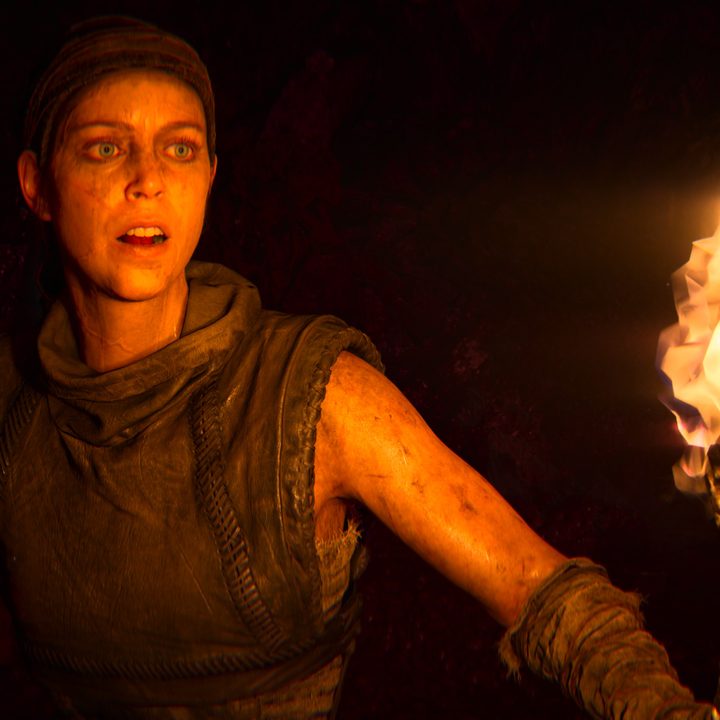 Senua carries a torch in Hellblade: Senua's Sacrifice.