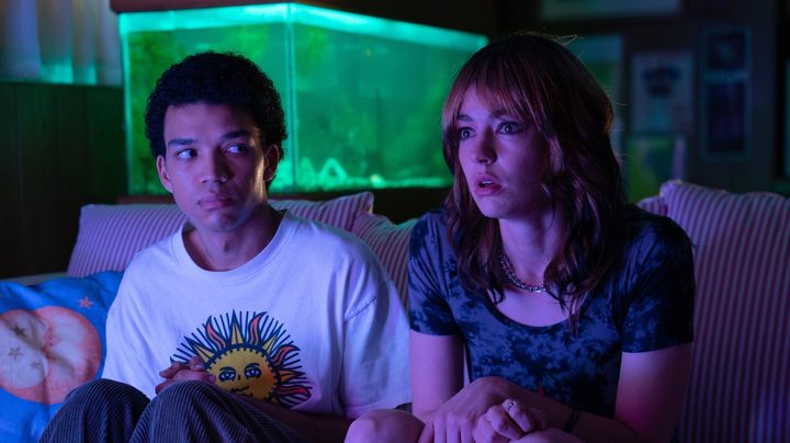 Justice Smith and Brigette Lundy-Paine watch TV with rapt attention in a screenshot from I Saw the TV Glow.