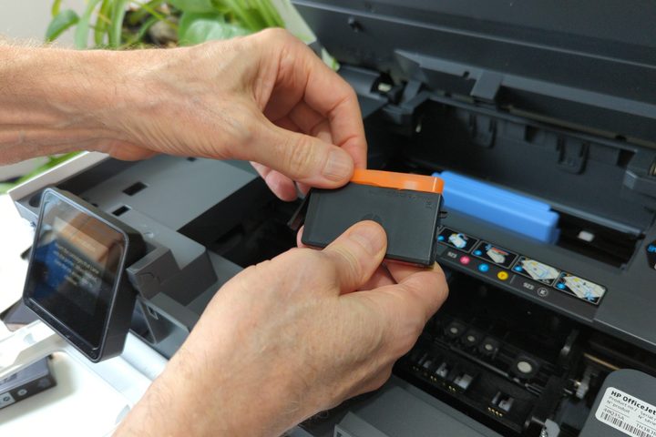 It's hard to remove the OfficeJet Pro 8135e's orange ink cartridge covers.