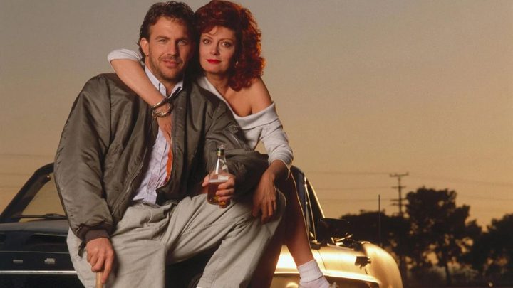 Kevin Costner and Susan Sarandon as Crash Davies as Annie Savoy embracing and looking at the camera in Bull Durham.