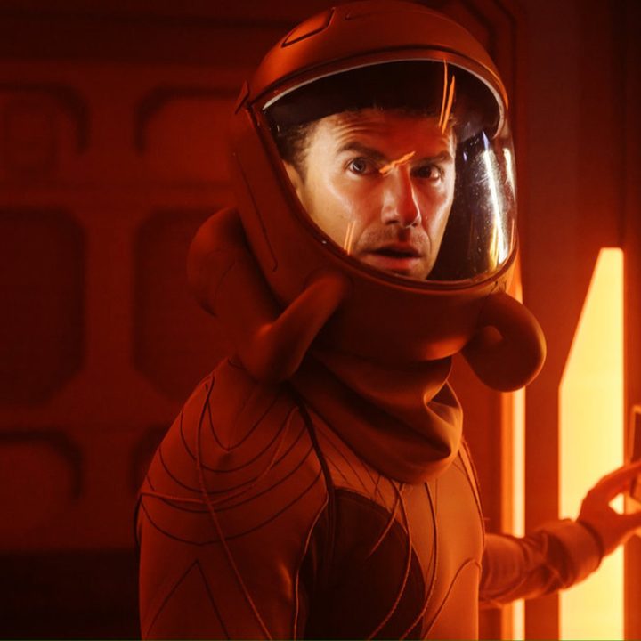 An astronaut looks confused with his suit on.