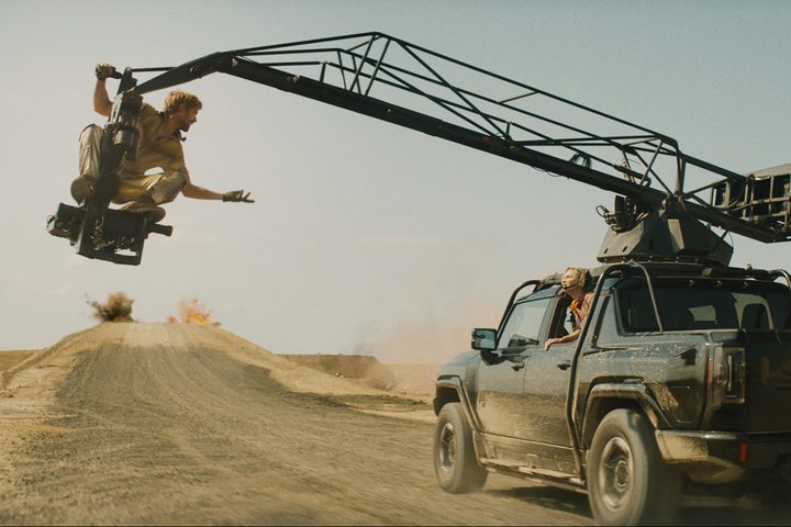 Ryan Gosling sits on a camera jib next to a truck in The Fall Guy.