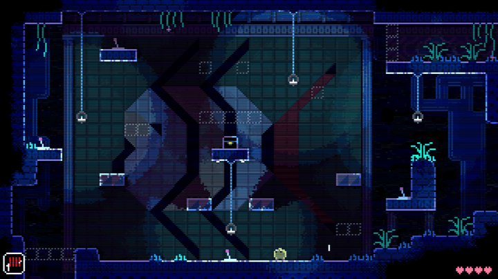 A blob stands in front of a fish mural in Animal Well.