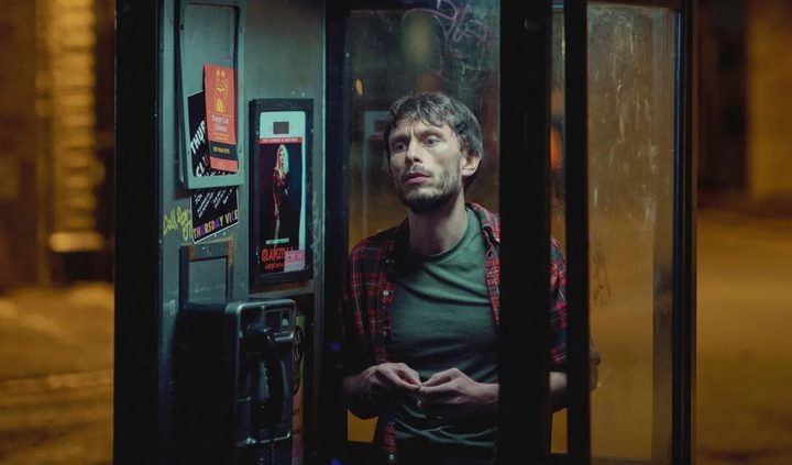 A man stands in a telephone booth in Baby Reindeer.