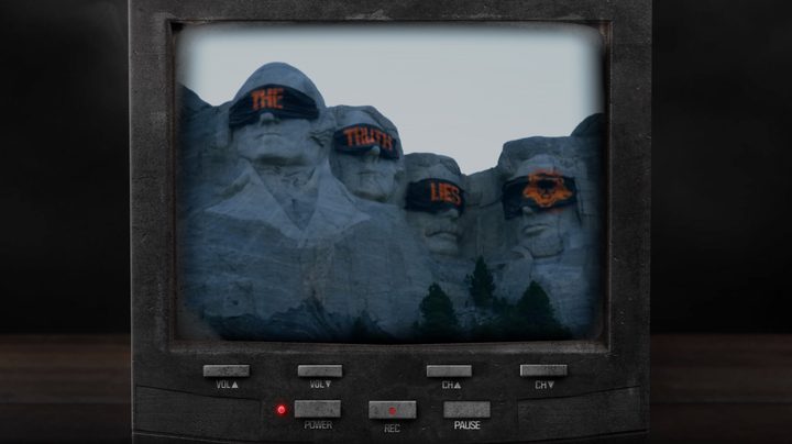 Mount Rushmore's heads covered in bandanas that say "the truth lies." The image is on an old TV.