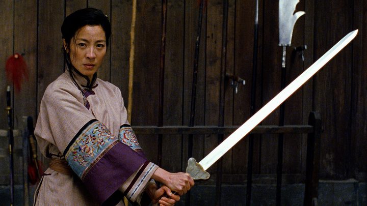 Michelle Yeoh wielding a sword in a scene from Crouching Tiger, Hidden Dragon.