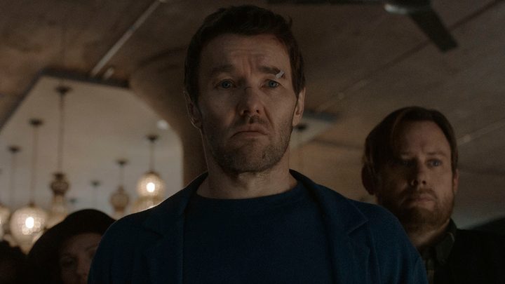 A man standing with a cut on his head looking worried, another behind him in a scene from Dark Matter on Apple TV+.
