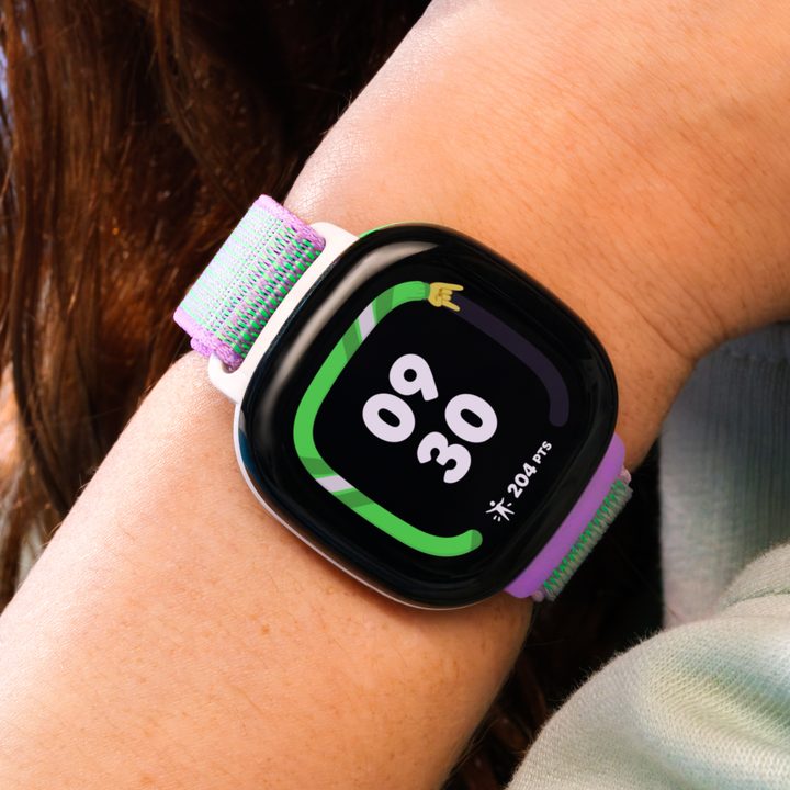 A photo of a kid wearing a Fitbit Ace LTE.