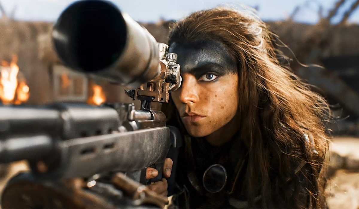 Furiosa aims her rifle in "Furiosa: A Mad Max Saga."