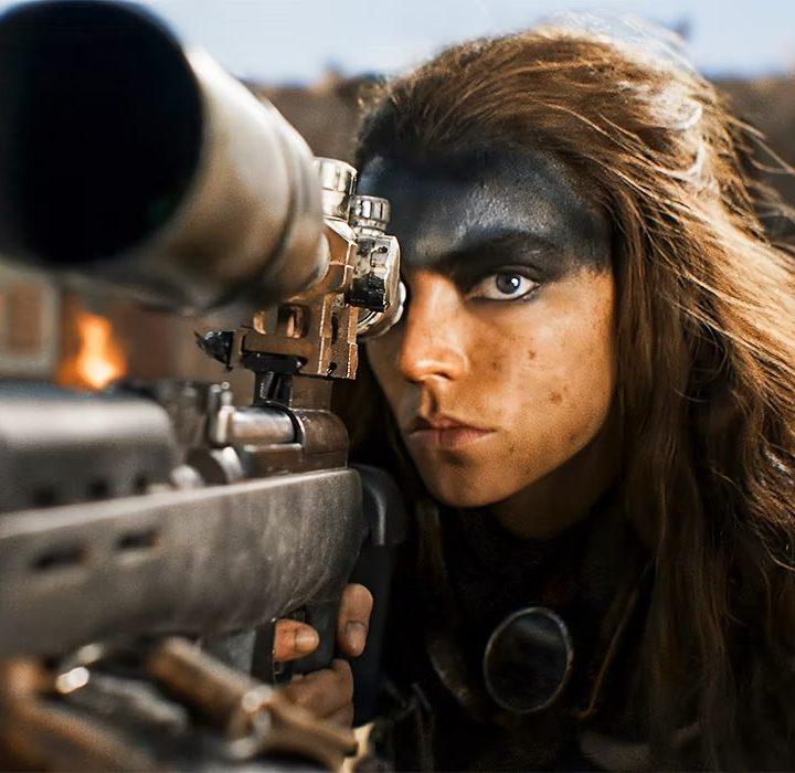 Furiosa aims her rifle in "Furiosa: A Mad Max Saga."