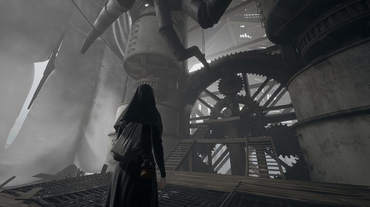 Indika stands in a room fill of machinery.