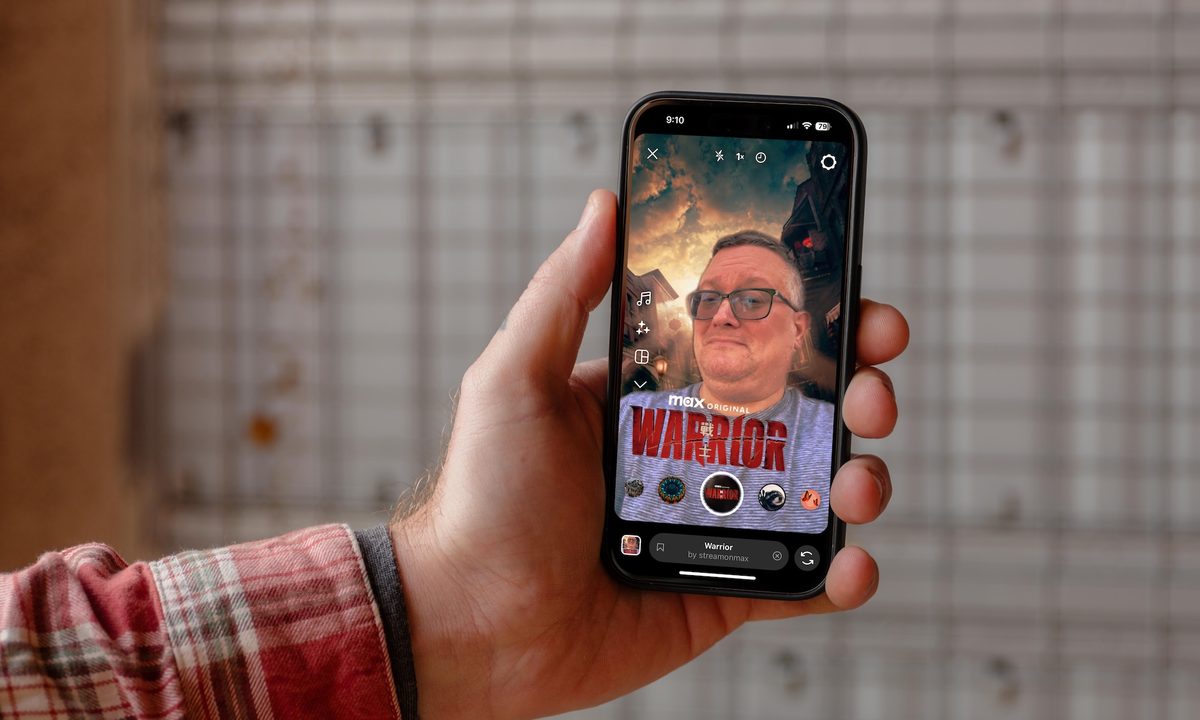 a hand holding an iPhone with the Instagram app showing.