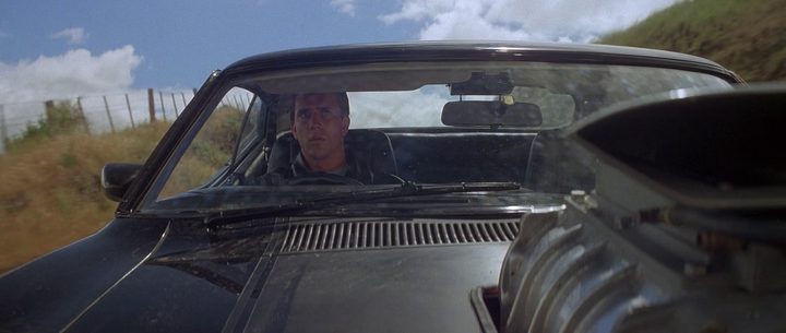 Mel Gibson as Max Rockatansky behind the wheel of his car in the original Mad Max