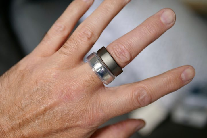 A person wearing an OSleeve cover on an Oura RIng.