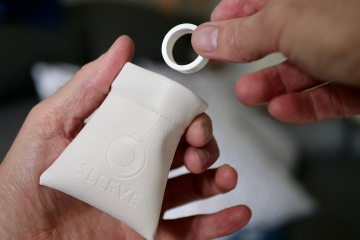 A person putting an OSleeve cover in a pouch.
