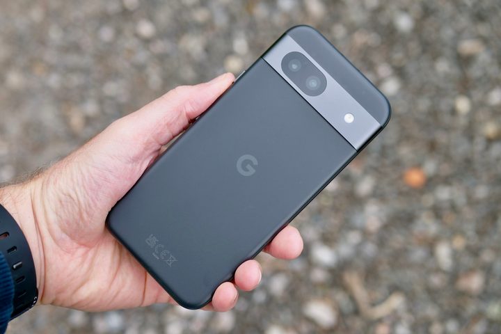 A person holding the Google Pixel 8a, showing the back.